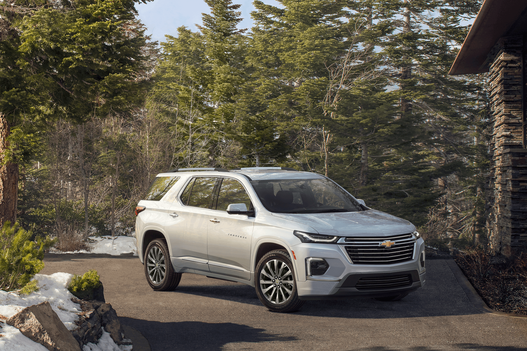 white chevy traverse parked in snowy driveway